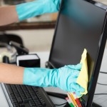 Close-up,Of,A,Woman's,Hand,Cleaning,The,Desktop,Screen,With